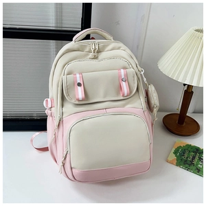 Detail of pink and beige patchwork backpack with round coin purse and large zip pocket