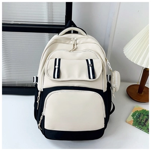 Detail of the high-capacity student backpack featuring contrast colors and a mini coin pouch