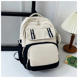 Detail of canvas backpack with black and white color blocking and mini coin purse