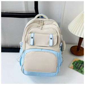 Close-up of beige and blue school backpack with functional pockets and stylish stationery
