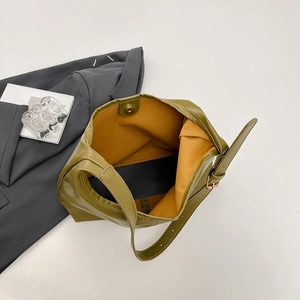 Olive green leather tote bag with mustard lining and adjustable shoulder strap