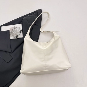Minimalist cream white hobo tote bag with vertical stitching and wide adjustable strap