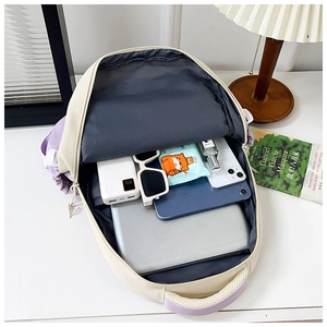 Top view of spacious beige and purple backpack interior with laptop and gadget organizers