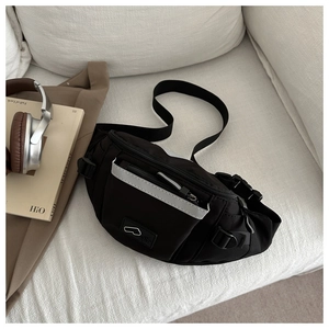Close-up of black waterproof sports waist bag with reflective strip and adjustable strap