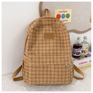 Detailed view of vintage brown checkered backpack with premium leather brand label