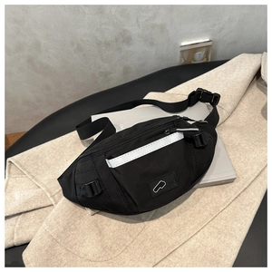 Close-up of waterproof black nylon sports waist bag with reflective strip and adjustable buckle