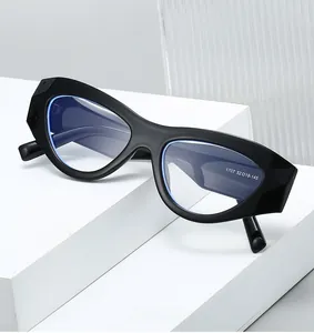 Detail view of black thick-frame cat-eye glasses with geometric edges and blue light lens
