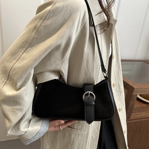 Minimalist black crescent shoulder bag with silver buckle and matte leather finish