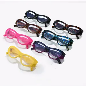 Flat lay of colorful thick-frame cat-eye glasses in black, pink, yellow, and tortoiseshell