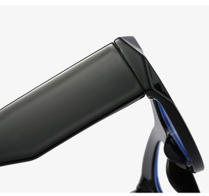 Detail of reinforced metal hinge and wide temple on black cat-eye eyeglass frames