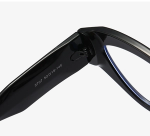 Detail of metal hinge and printed size specs 52-19-145 on black cat-eye glasses frame