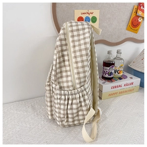 Side view of brown and white checkered backpack featuring elastic mesh water bottle pocket