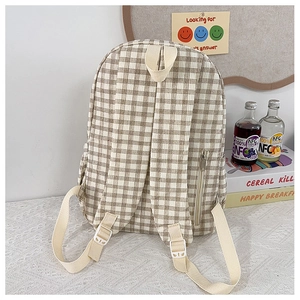 Detail of checkered backpack back with adjustable straps and hidden side zipper pocket