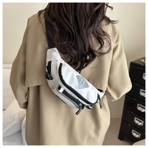 Detailed back view of model wearing white nylon crossbody bag with adjustable strap