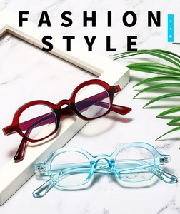 Flat lay of vintage semi-round sunglasses in dark red and transparent sky blue frames