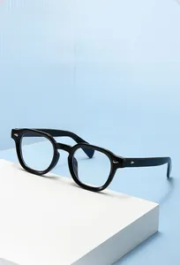 Detail of retro black round glasses frame with silver arrow accents on blue background