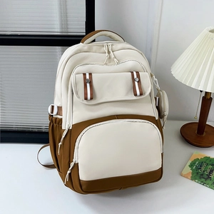 Minimalist beige and brown nylon backpack with multiple zipper pockets and small side pouch