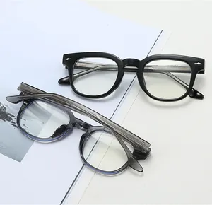 Detail of retro black and transparent grey TR90 frames with silver leaf rivets