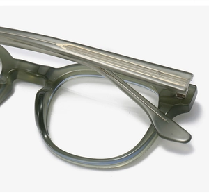 Macro detail of transparent olive green TR90 glasses frame with metallic inner core