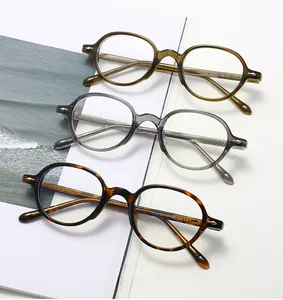 Detailed view of three vintage oval eyewear frames in olive green, grey, and tortoiseshell