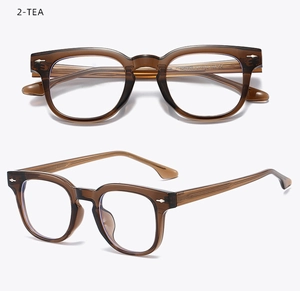 Detail view of tea-colored transparent square TR90 eyewear frames with metal rivets