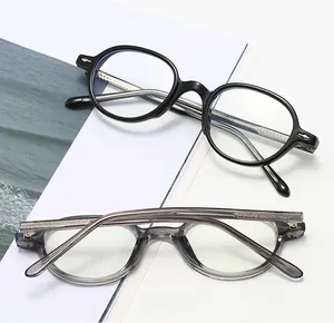 Detailed view of vintage oval glasses in classic black and transparent grey acetate frames