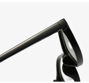 Detailed macro view of the polished black resin frame hinges and sleek temple connection