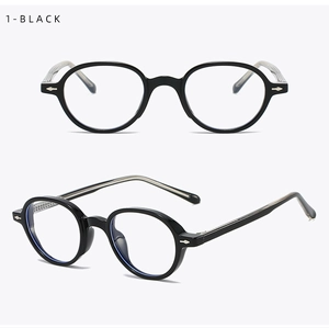 Detail of vintage oval black glasses frames featuring silver arrow metal rivets
