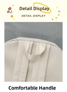 Detail of comfortable top handle and wide shoulder straps on cream white backpack