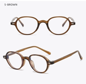 Close-up detail of vintage oval brown glasses frame with silver rivet decorations