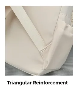 Detail of triangular reinforcement stitching on beige backpack shoulder straps