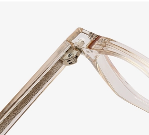 Macro shot of durable metal hinge and vintage engraved core inside champagne eyeglass frame