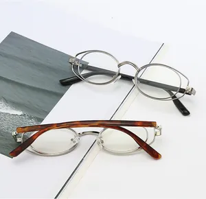 Detail of silver oval eyeglass frames with unique double-ring hollow design and tortoise temples