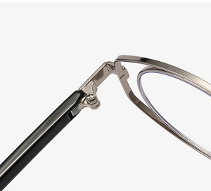 Macro shot of durable silver metal hinge connecting a black temple on fashion glasses