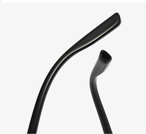 Close-up of ergonomic glossy black temple tips of oval futuristic eyeglasses