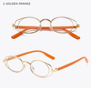 Detail view of oval double-frame metal glasses with golden rims and bright orange temples