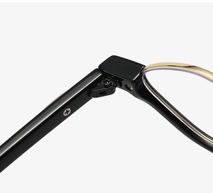 Detail of vintage round frame glasses showing the durable gold metal hinge and blue light lens
