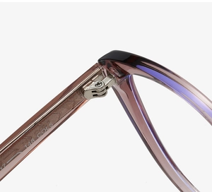 Macro shot of durable metal hinge and temple engraving on cat-eye eyewear frames