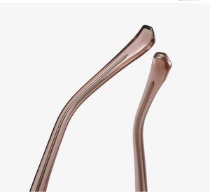 Macro shot of cat-eye sunglasses temple tips with translucent brown finish and metal core