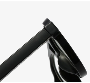 Detailed close-up of premium black aviator sunglasses showing durable metal hinges and frame