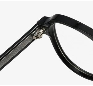 Close-up of reinforced metal hinges and internal wire core on black aviator glasses