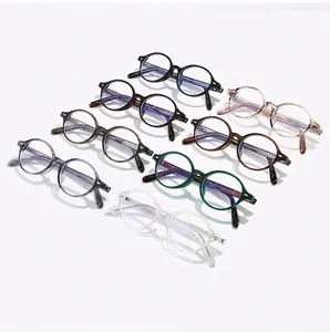Various colored retro oval eyewear frames with anti-blue light lenses in a tidy layout