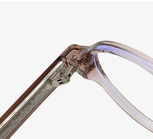 Close-up detail of the durable metal hinge on translucent acetate eyeglass frames