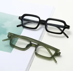 Detail of square glasses frames in black and olive green with silver rivet accents