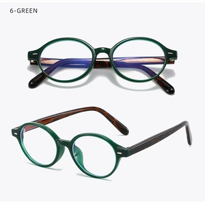 Macro view of transparent dark green oval glasses frame with tortoiseshell temples
