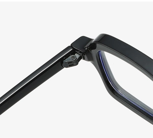 Detailed close-up of the metal hinge connection on black square eyeglass frames