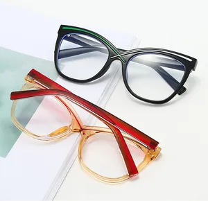 Detail of cat eye glasses frames in black with green stripes and transparent amber with red arms