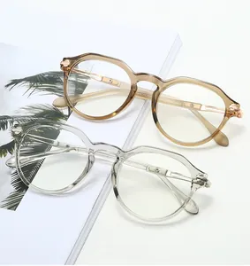 Detail view of transparent grey and tea-colored TR90 vintage oval eyeglasses frames