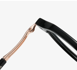 Detail of rose gold metal hinges and black TR90 frame with precision screw fixing