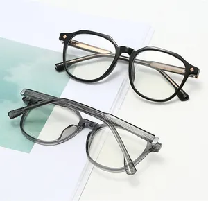 Detail of retro oval TR90 eyeglass frames in glossy black and transparent grey colors